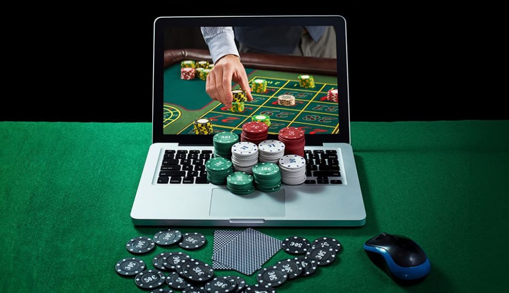 green-table-with-casino-chips-cards-notebook